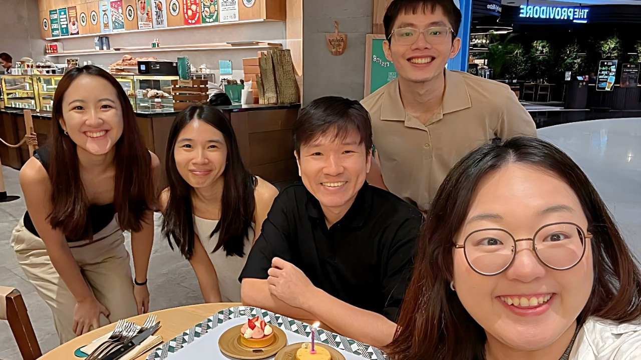 Photo of Kai Soon and his colleagues at a team birthday celebration