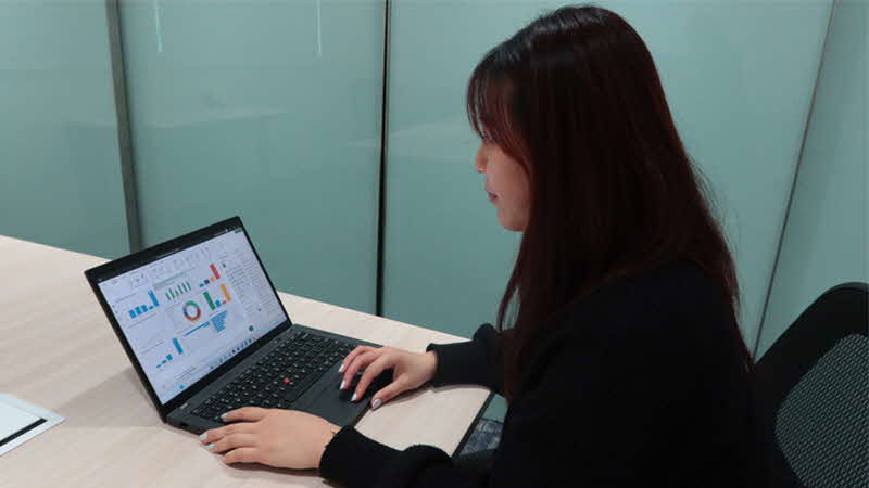 Tan Hui Xin reviewing data visualisations and analytics in her course of work.