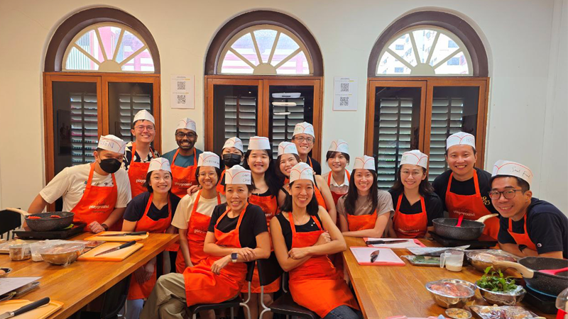 Faith and her Energy Connections Office colleagues during a cooking class team building session.